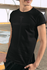 Person wearing a black t-shirt and shorts standing outdoors.