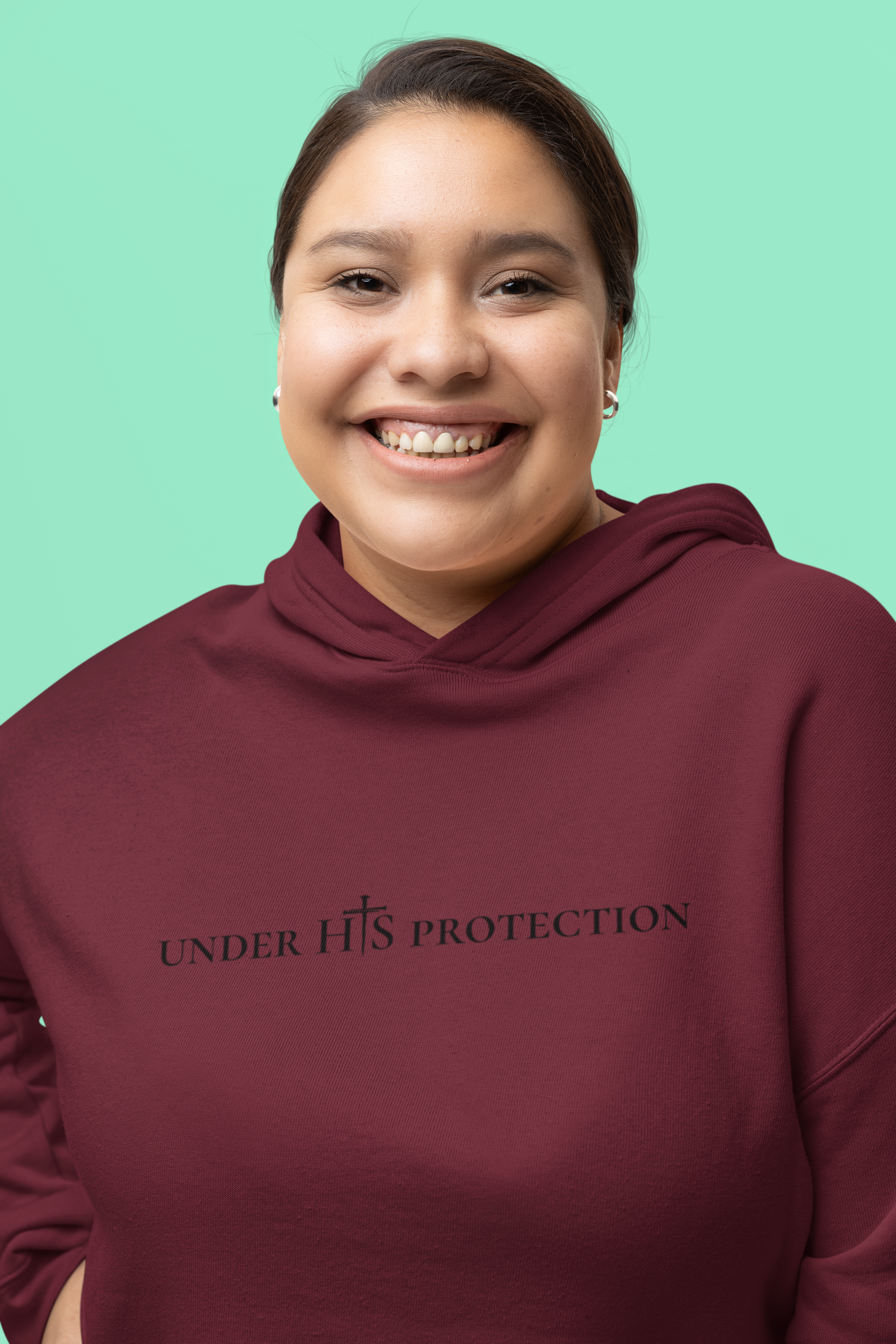 Person wearing “Under His Protection” hoodie by MyCreed with scripture design on front.