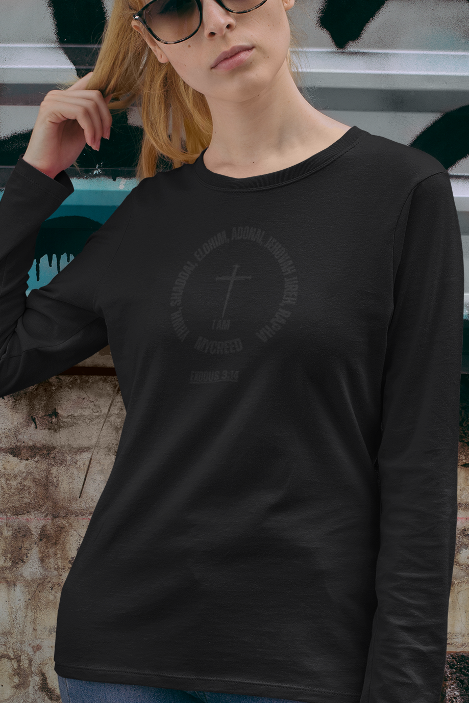 Faith-inspired long sleeve women’s tee by MyCreed, showcasing names of God in modern graphic layout.