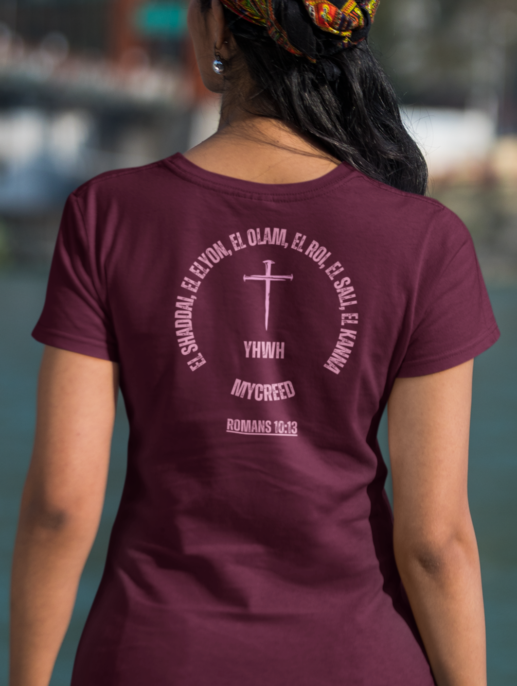 Close-up of YHWH’s Names women’s Bella+Canvas tee featuring Romans 10:13 and cross emblem