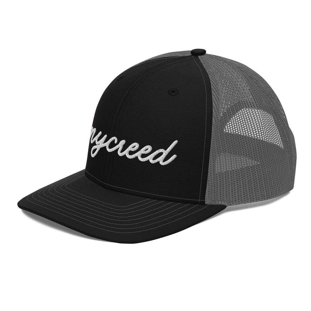 Angled side view of black MyCreed™ logo trucker cap with charcoal mesh back by MyCreed™