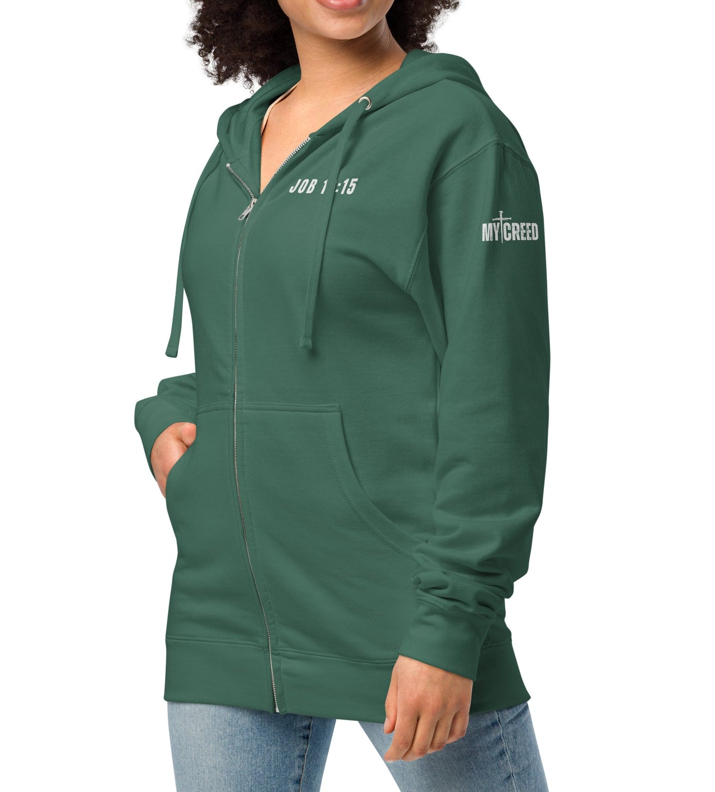 Alpine green zip-up hoodie worn by female model, front view showing subtle “Job 13:15” chest scripture by MyCreed™