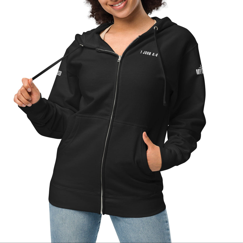 Black zip-up hoodie on female model, front view with left chest “1 JOHN 4:4” by MyCreed™