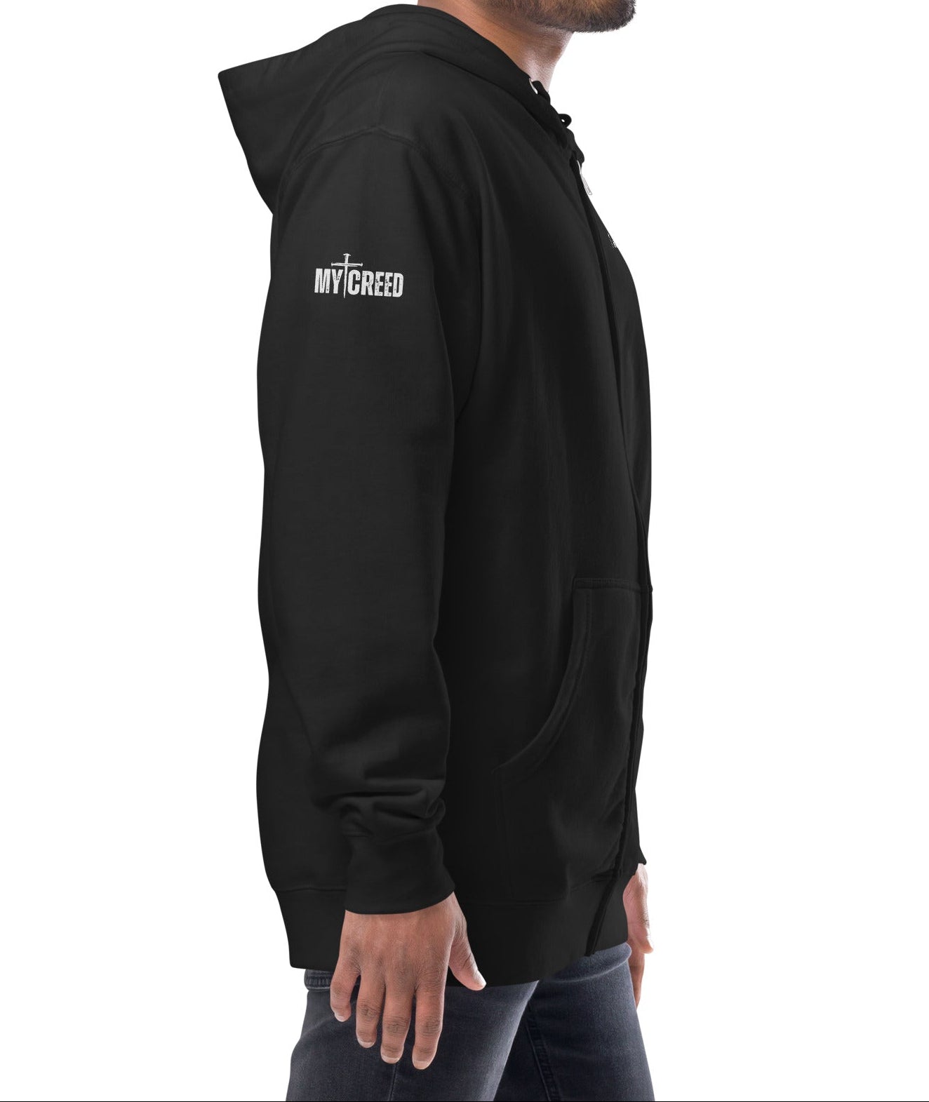 Black zip-up hoodie on model, side view with left chest “1 JOHN 4:4” detail by MyCreed™