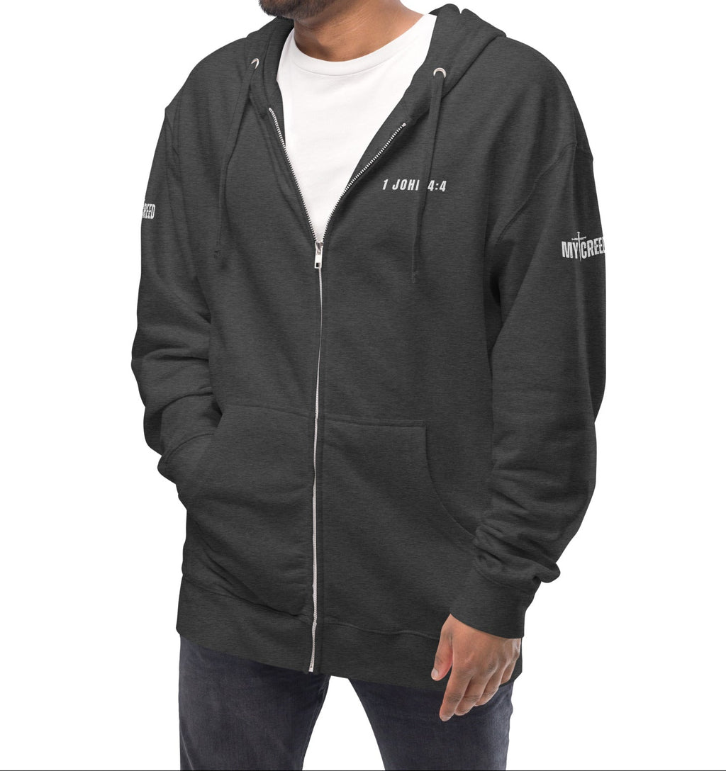 Charcoal heather zip-up hoodie on model, front view with left chest “1 JOHN 4:4” by MyCreed™