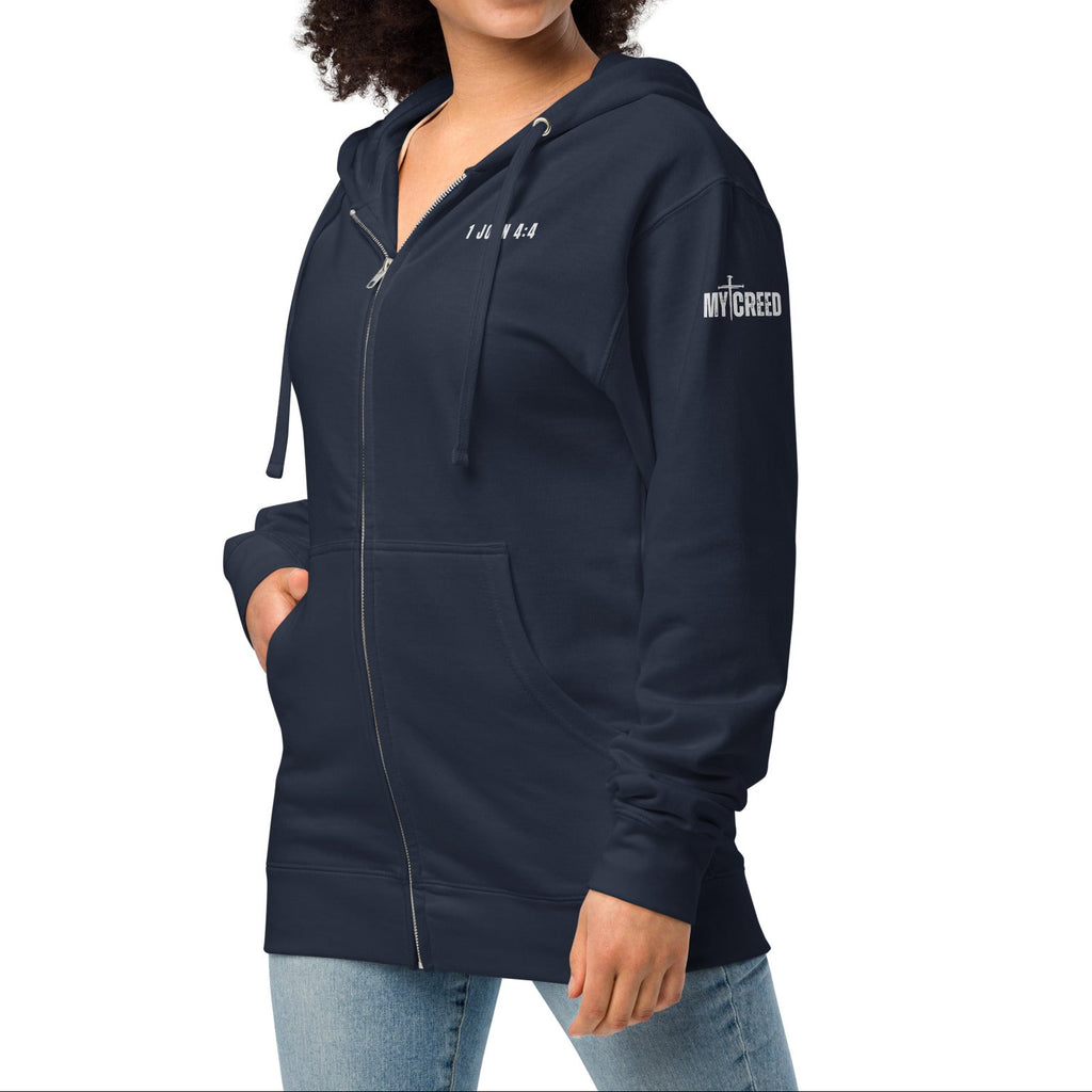 Navy zip-up hoodie on female model, front view with left chest “1 JOHN 4:4” by MyCreed™
