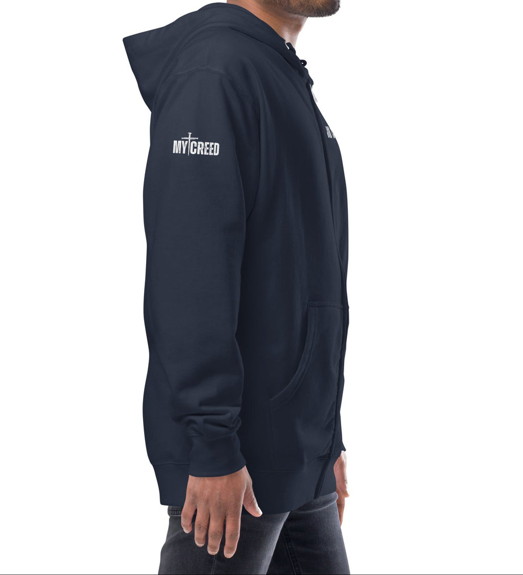 Navy zip-up hoodie worn by male model, right side profile showing clean My Creed logo, by MyCreed™