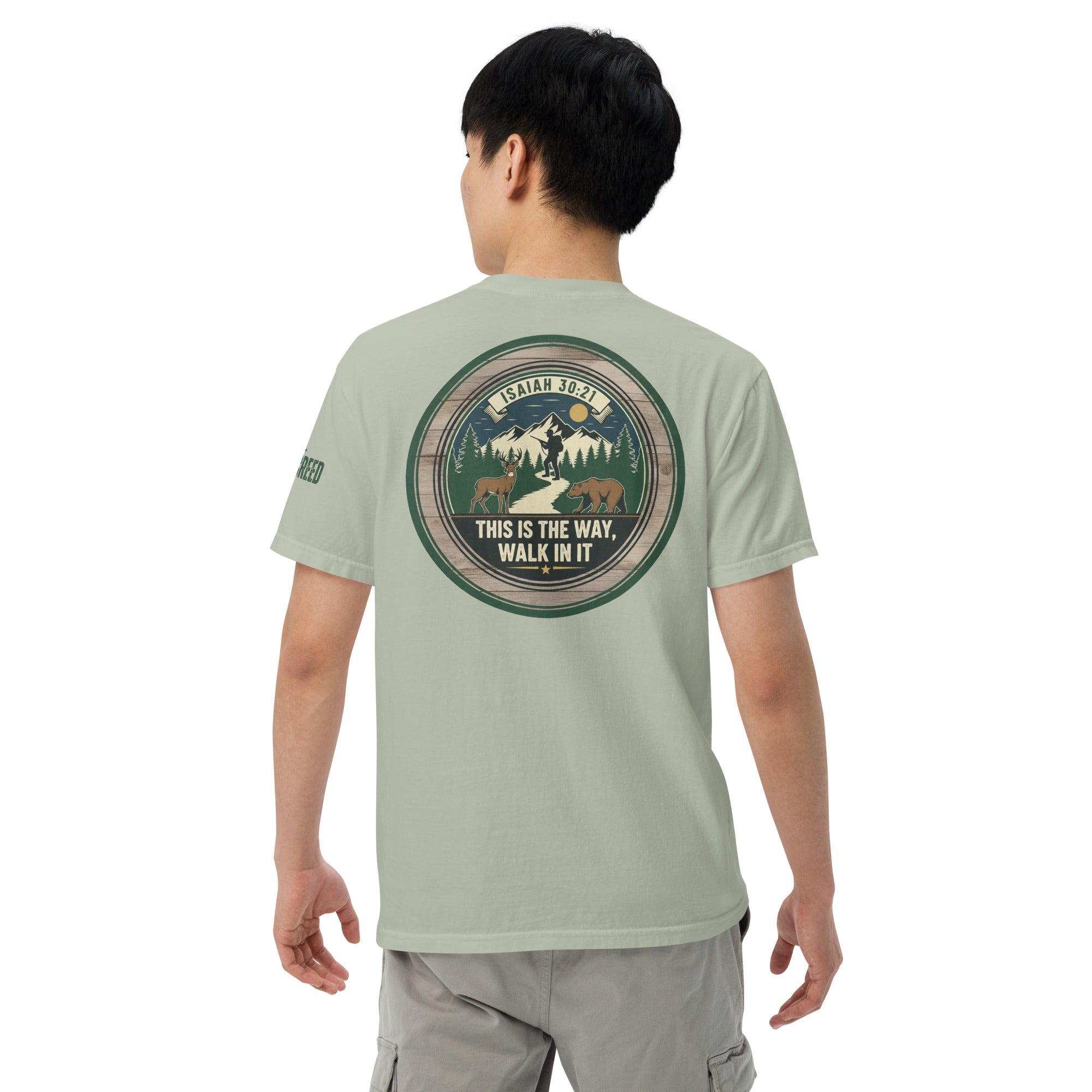 Lifestyle back view of man wearing sage green Comfort Colors tee showing full circular Isaiah 30:21 back artwork, by MyCreed™