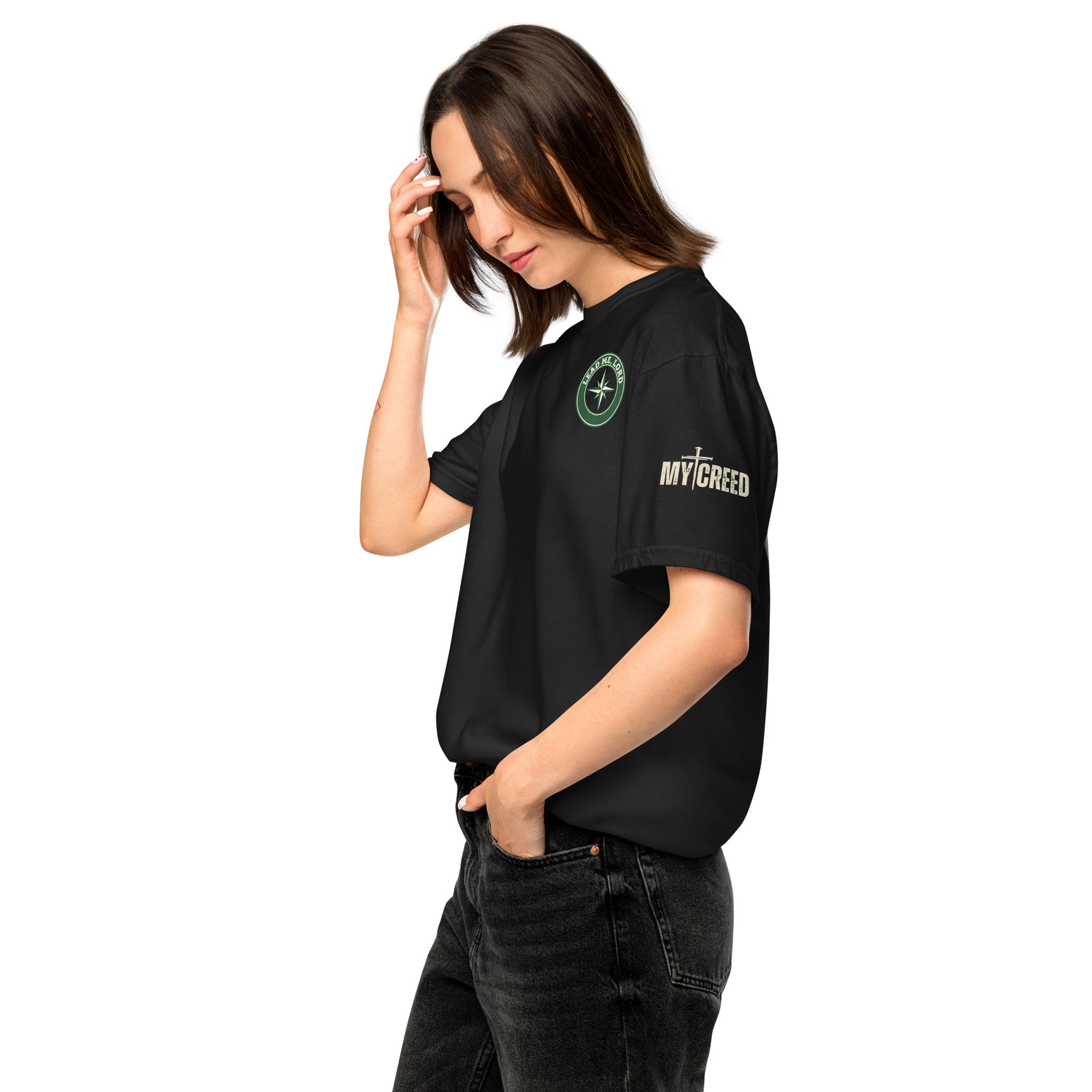 Lifestyle photo of woman in black Comfort Colors t-shirt showing subtle front chest emblem, by MyCreed™