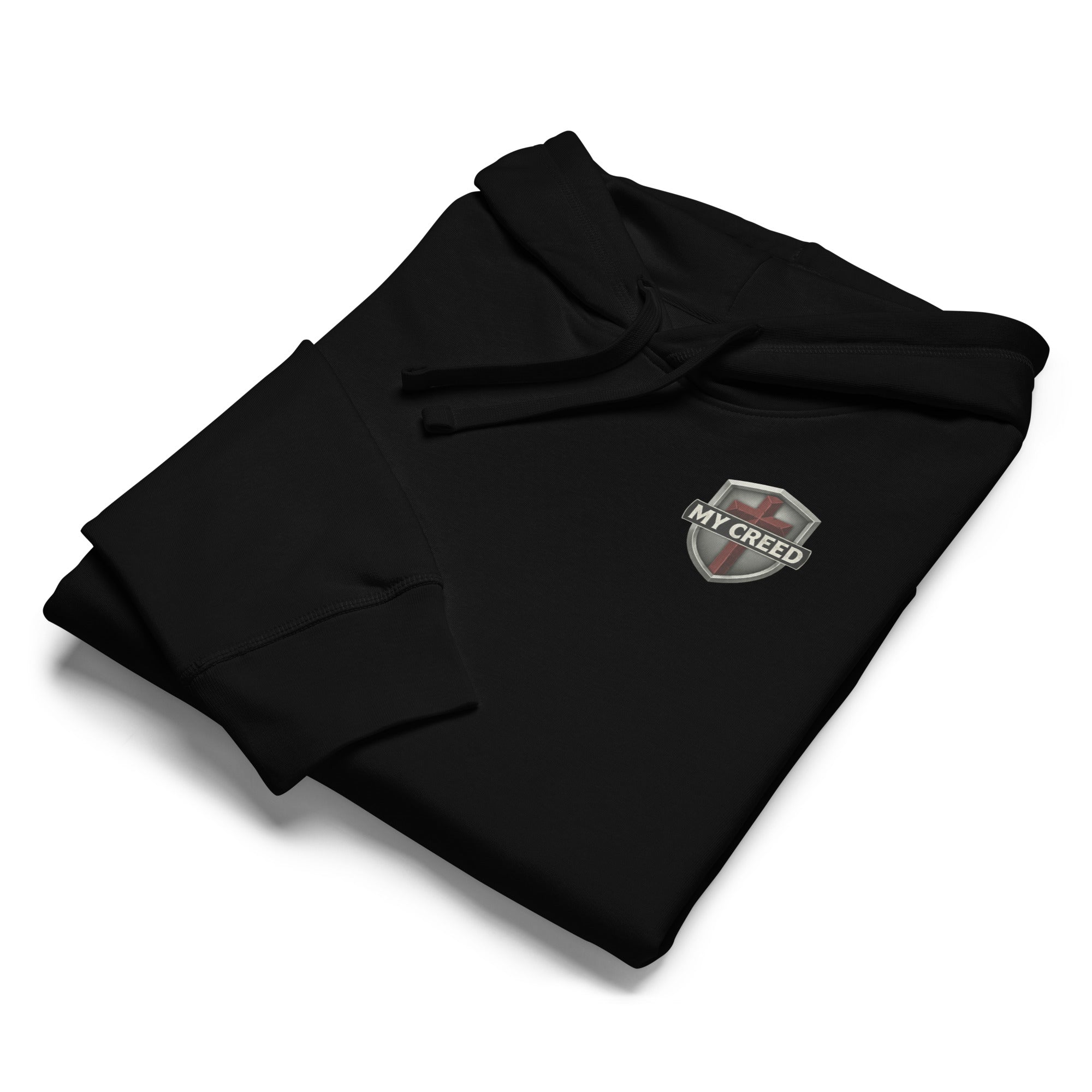 Folded black Stanley/Stella hoodie product flat-lay with small MyCreed crest visible by MyCreed™