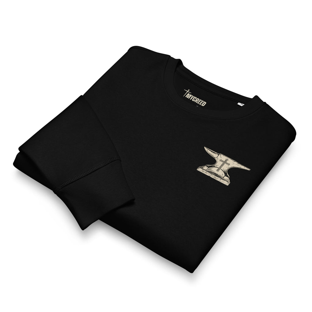 Folded black sweatshirt flat lay with chest emblem visible by MyCreed™