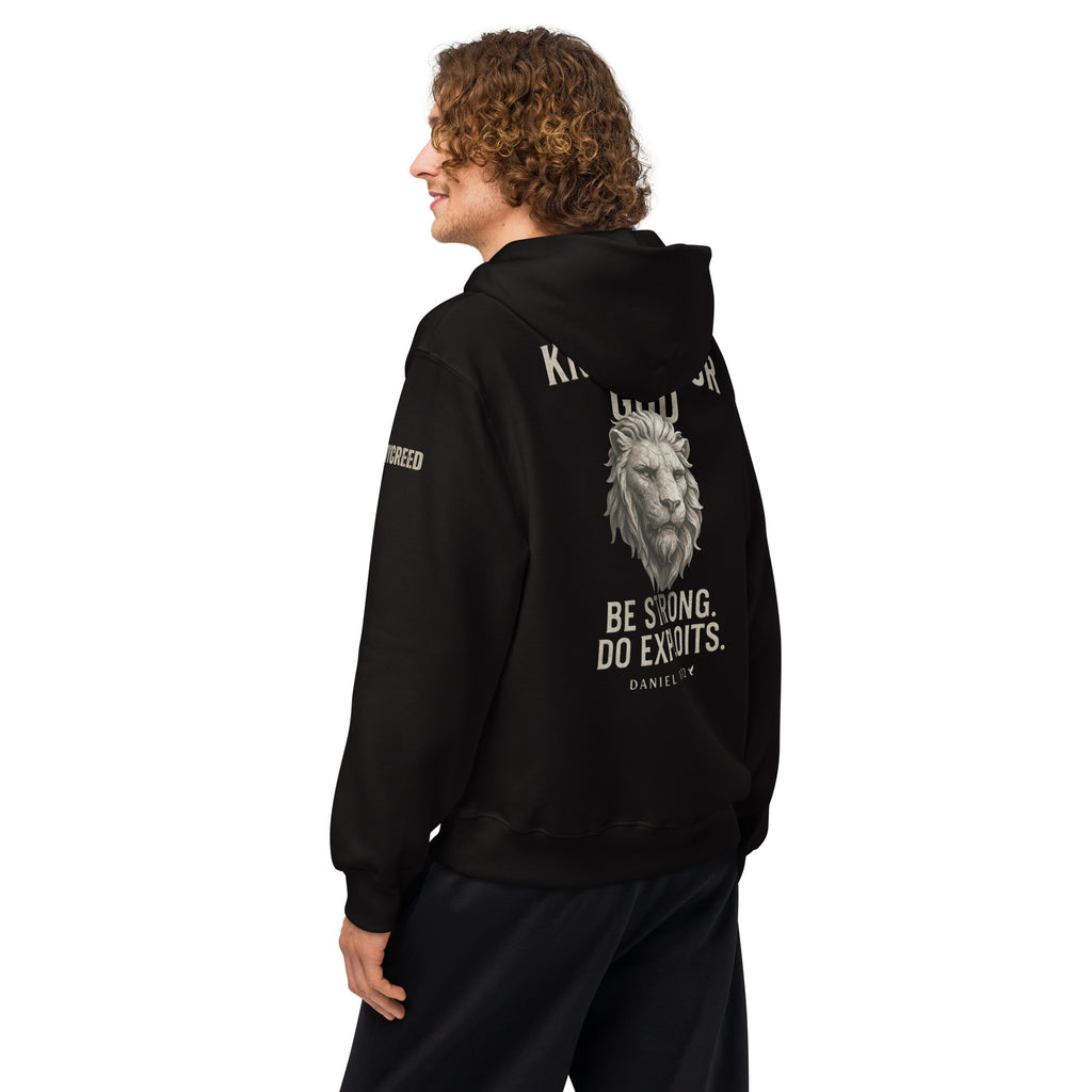 Model wearing Inspirational Christian black hoodie with back view Daniel 11:32 verse and bold lion artwork by MyCreed™
