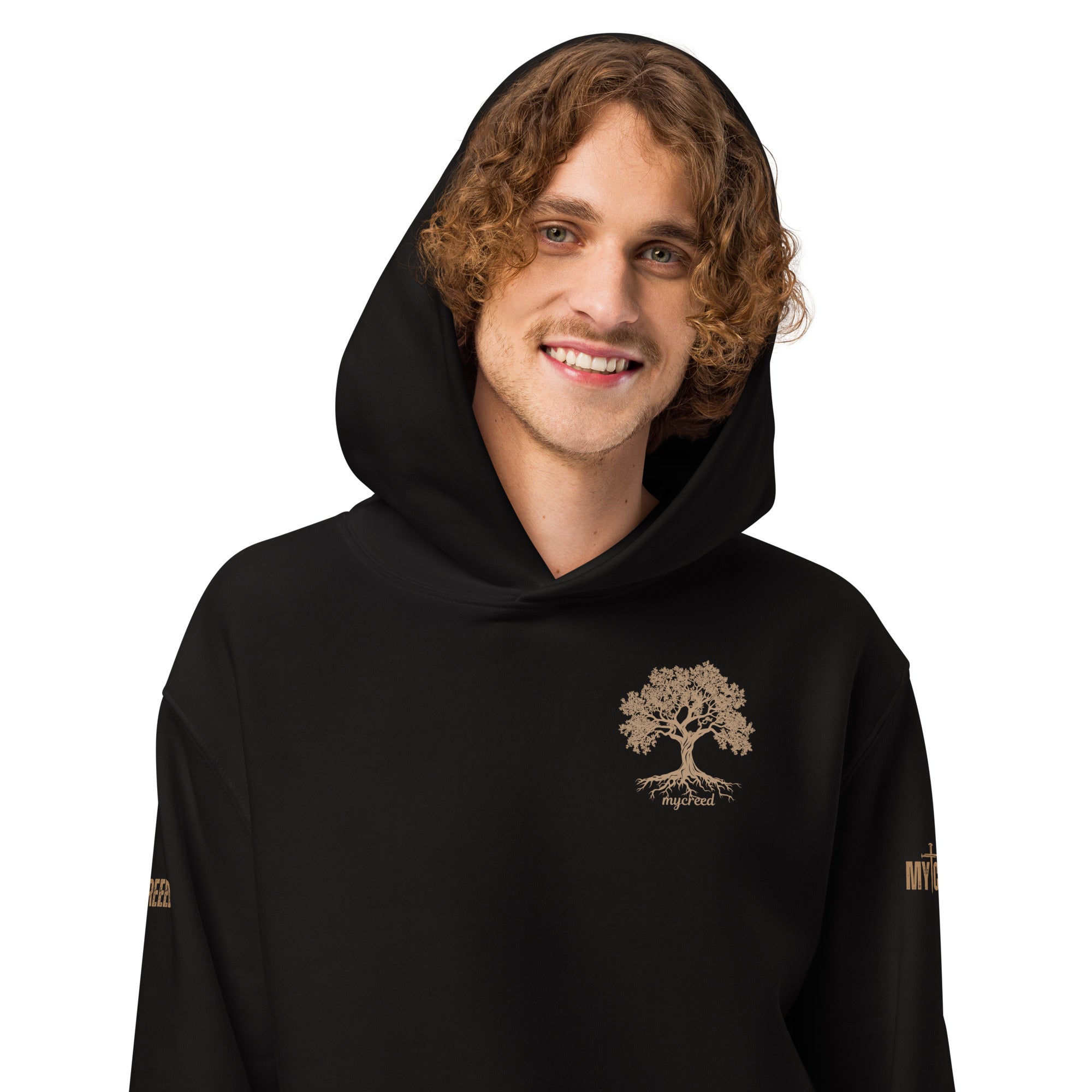 Male model wearing black hoodie, front view showing left-chest emblem by MyCreed™