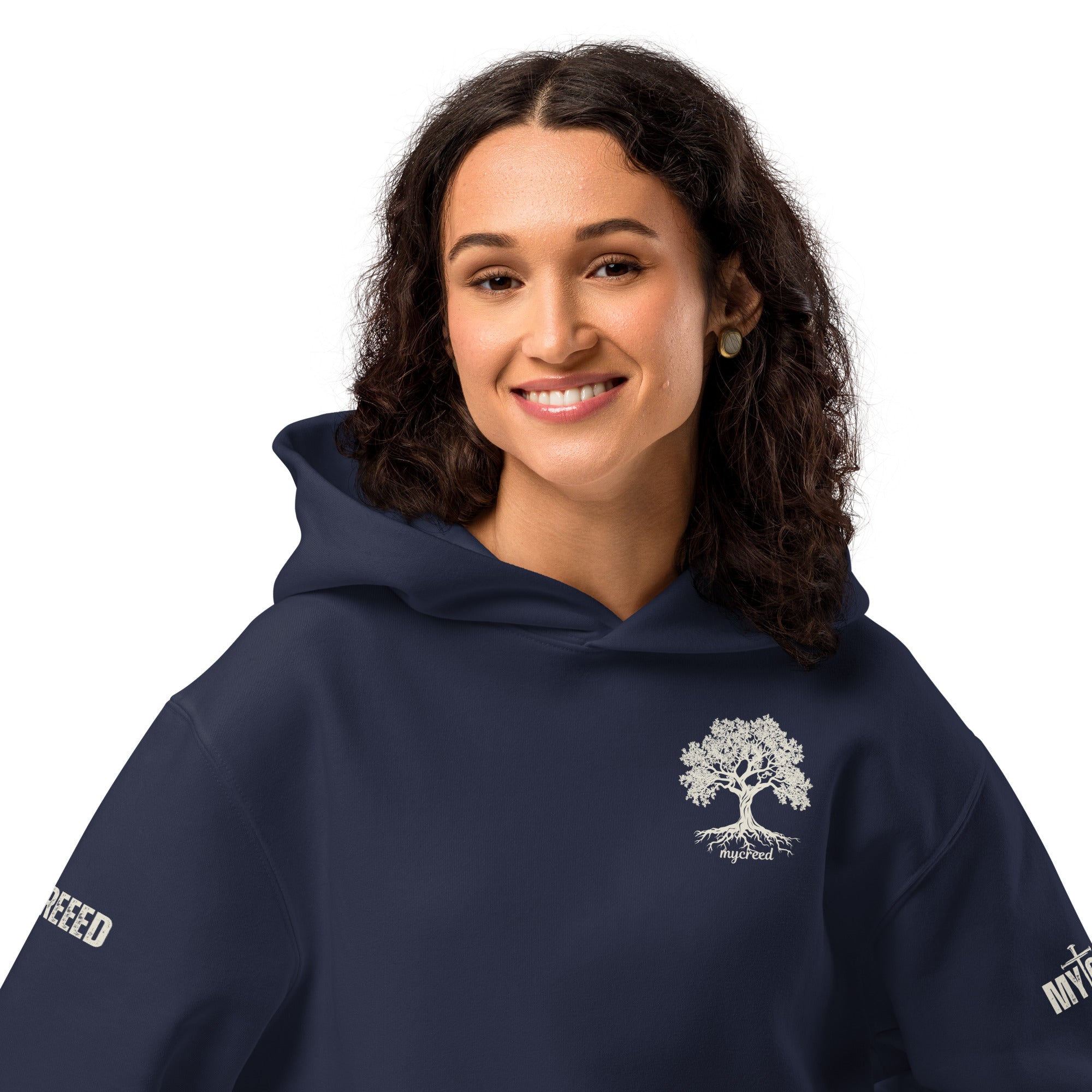 Female model wearing navy hoodie, front view showing left-chest emblem by MyCreed™