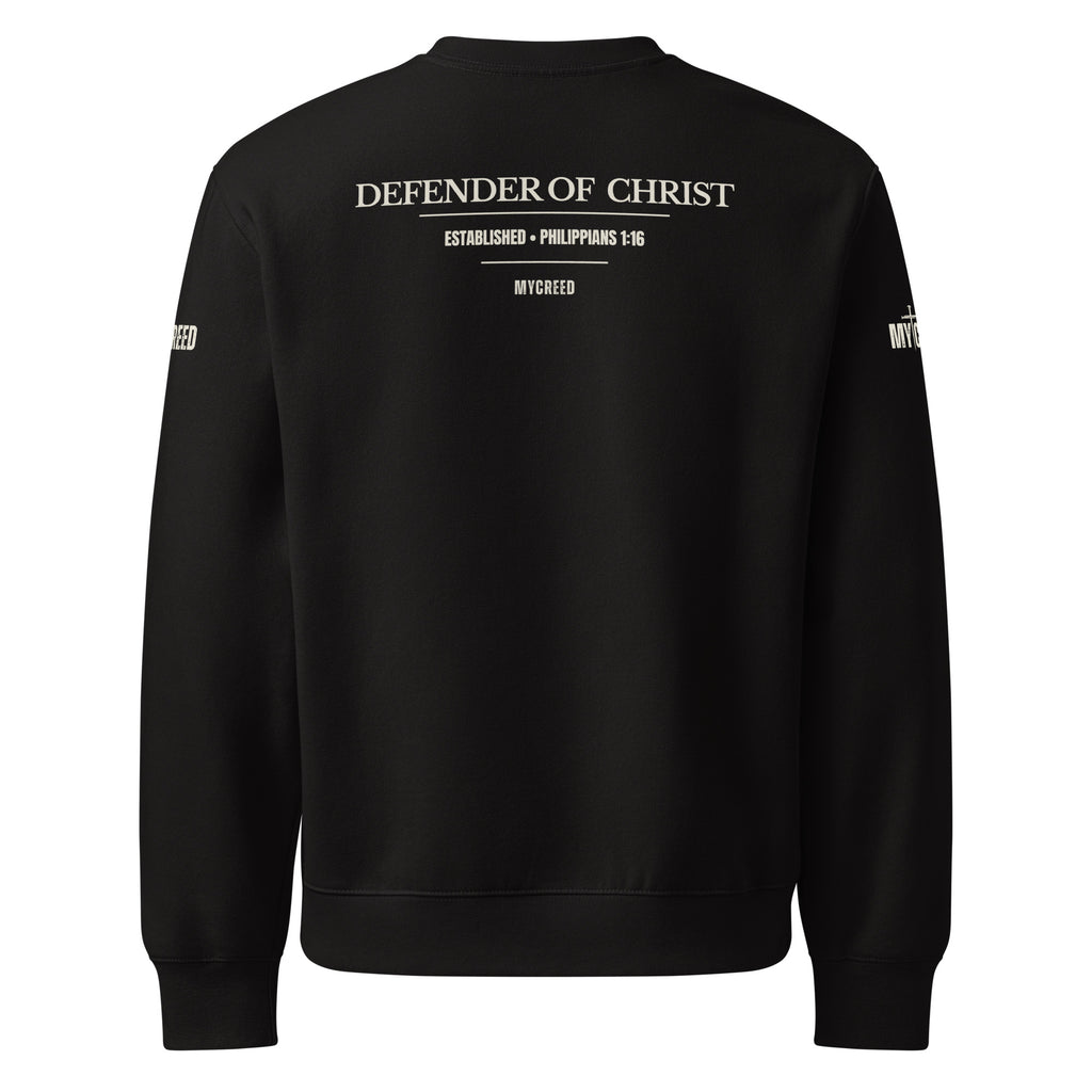 Black crewneck sweatshirt back view displaying the Defender of Christ design with Philippians 1:16 in parchment tone for high contrast on dark fabric, by MyCreed™