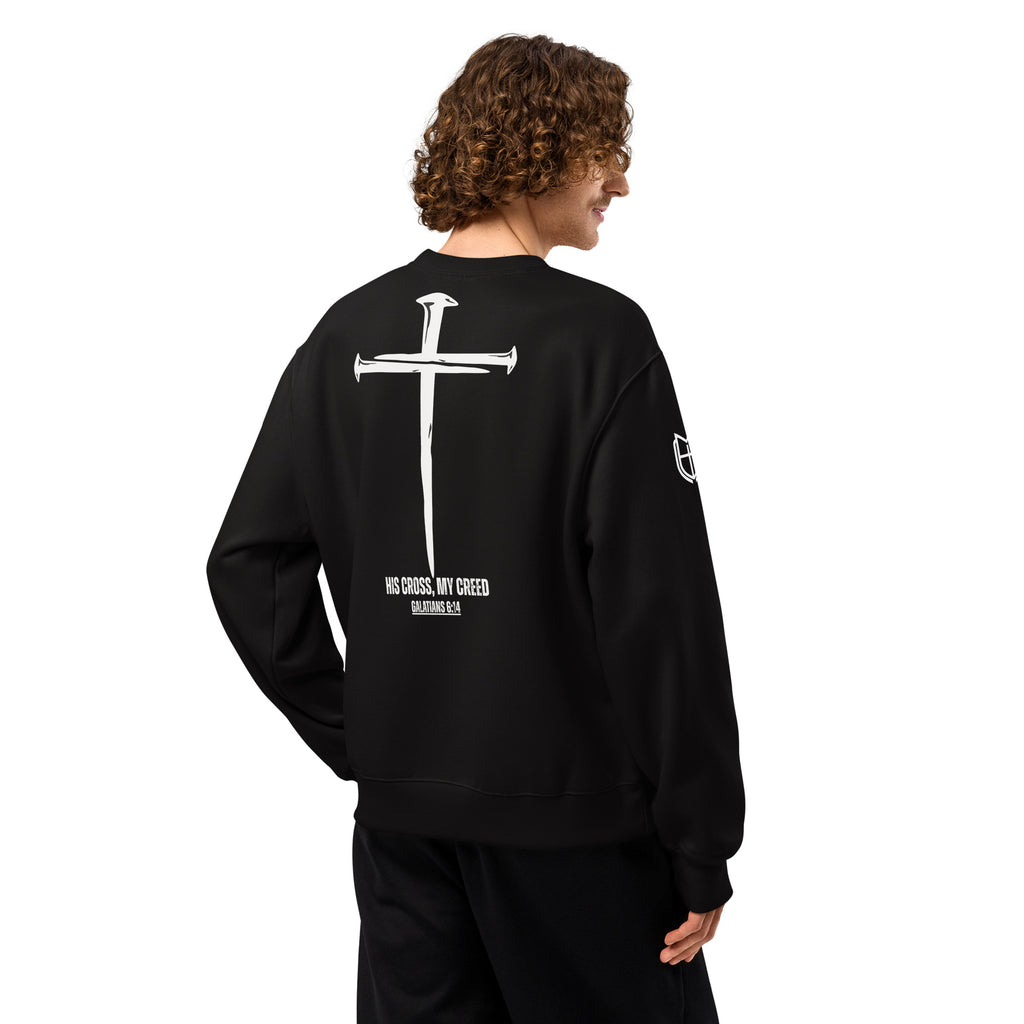 Black Bella+Canvas crewneck sweatshirt worn by model, back view with high-contrast cross faith graphic, by MyCreed™