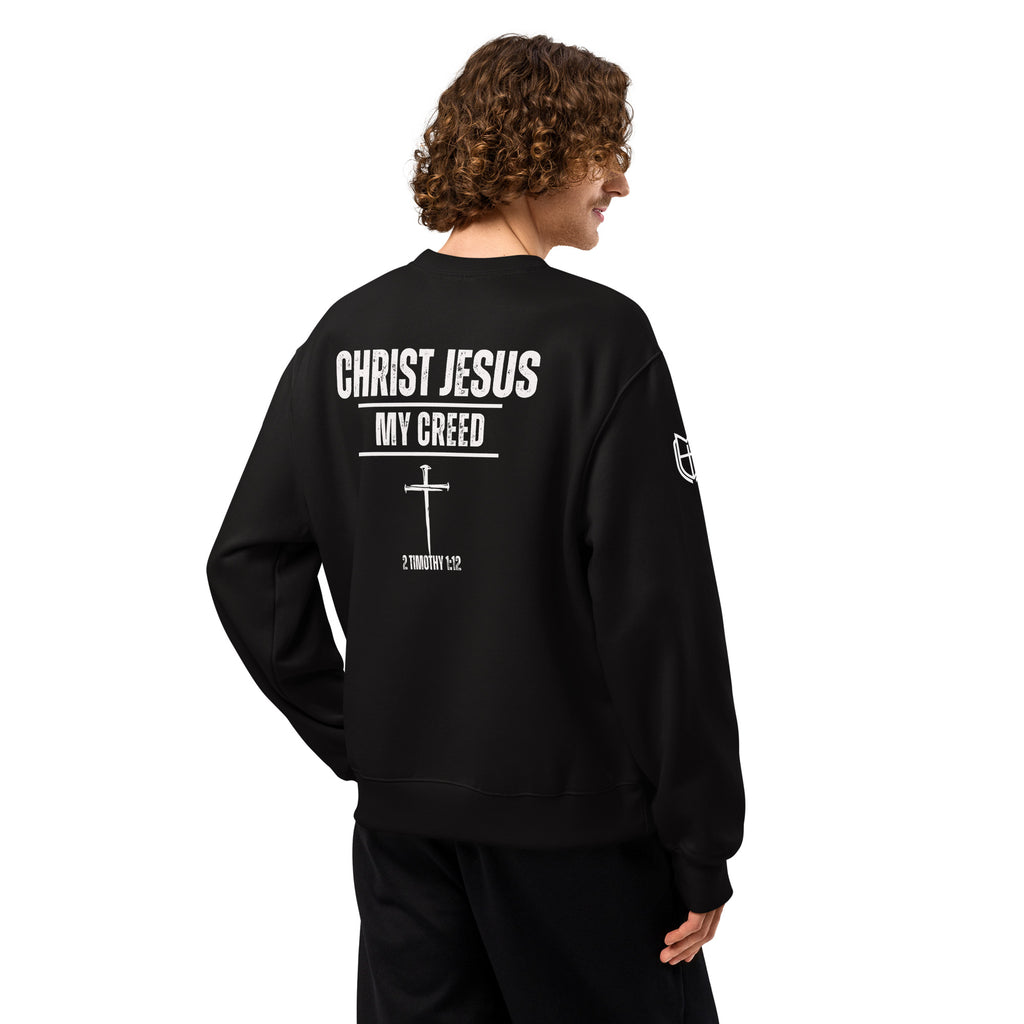 Back view of black Bella+Canvas 4711 oversized sweatshirt worn by model with Christ Jesus | My Creed design visible, by MyCreed™