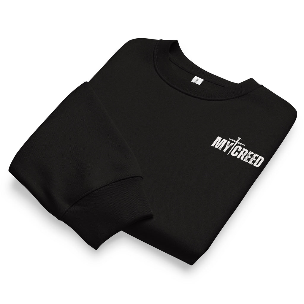 Folded black Bella+Canvas 4711 oversized sweatshirt showing premium fabric and MyCreed chest branding, by MyCreed™