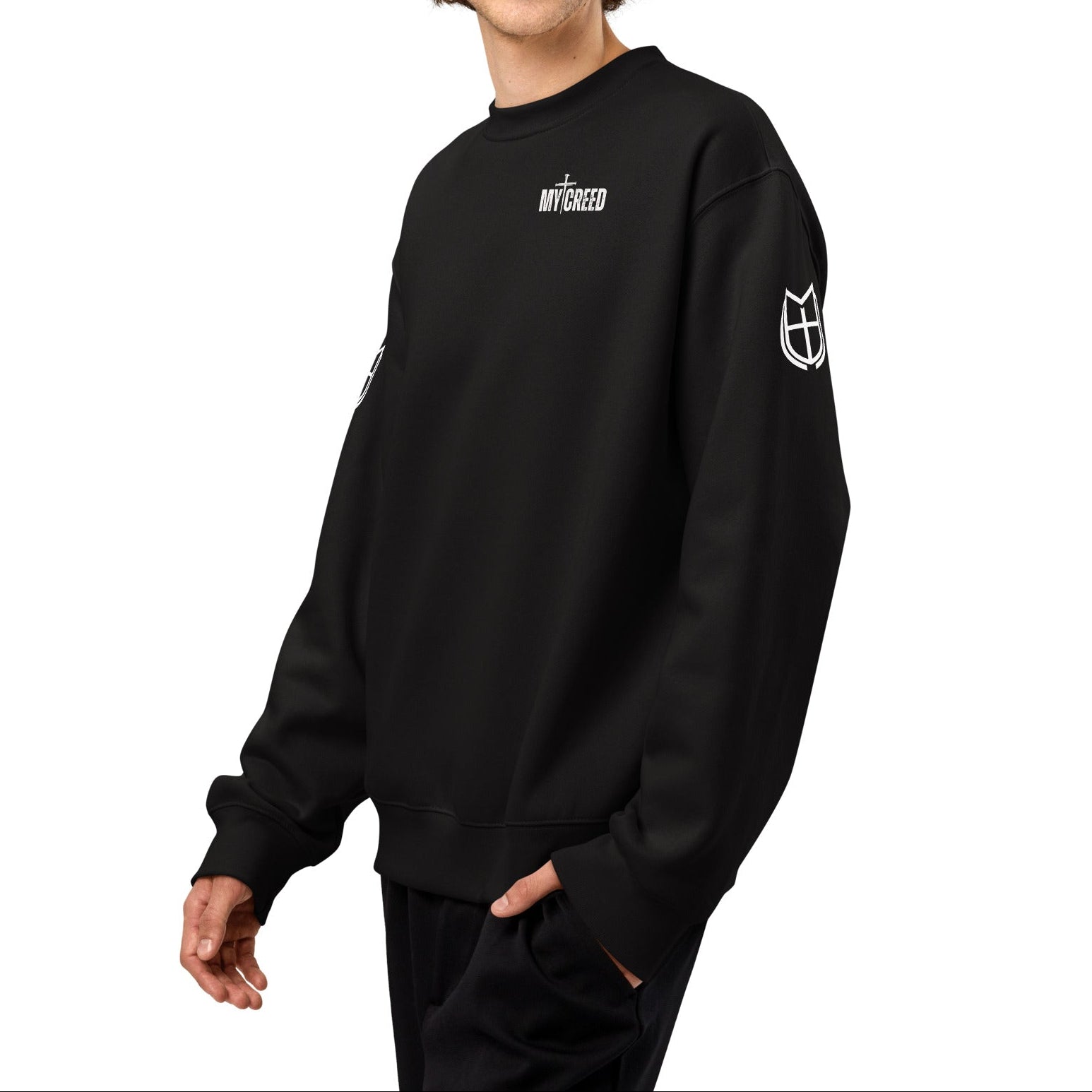 Black Bella+Canvas crewneck sweatshirt worn by model, front view with understated MyCreed chest mark, by MyCreed™