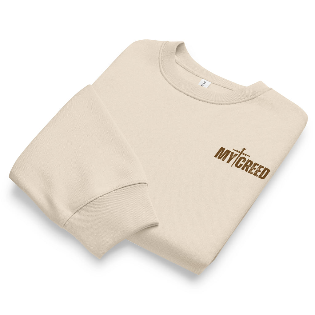 Folded dust Bella+Canvas 4711 oversized sweatshirt showcasing premium construction and chest branding, by MyCreed™