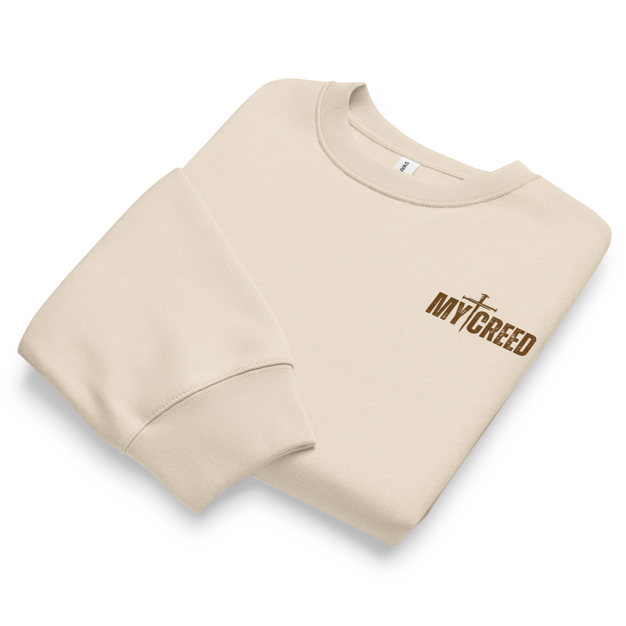 Folded dust Bella+Canvas 4711 oversized sweatshirt showcasing premium construction and chest branding, by MyCreed™