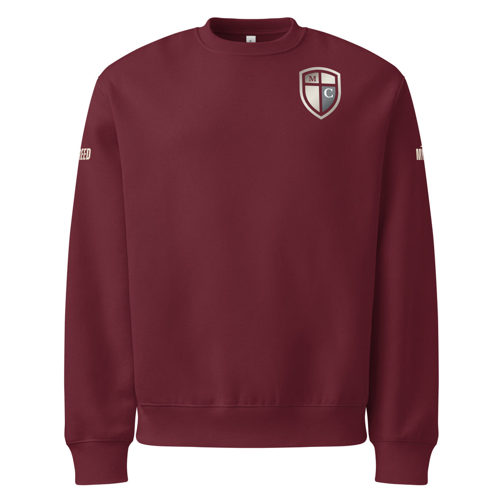 Maroon crewneck sweatshirt front view featuring the Defender of Christ shield emblem on the left chest with rich color depth, by MyCreed™