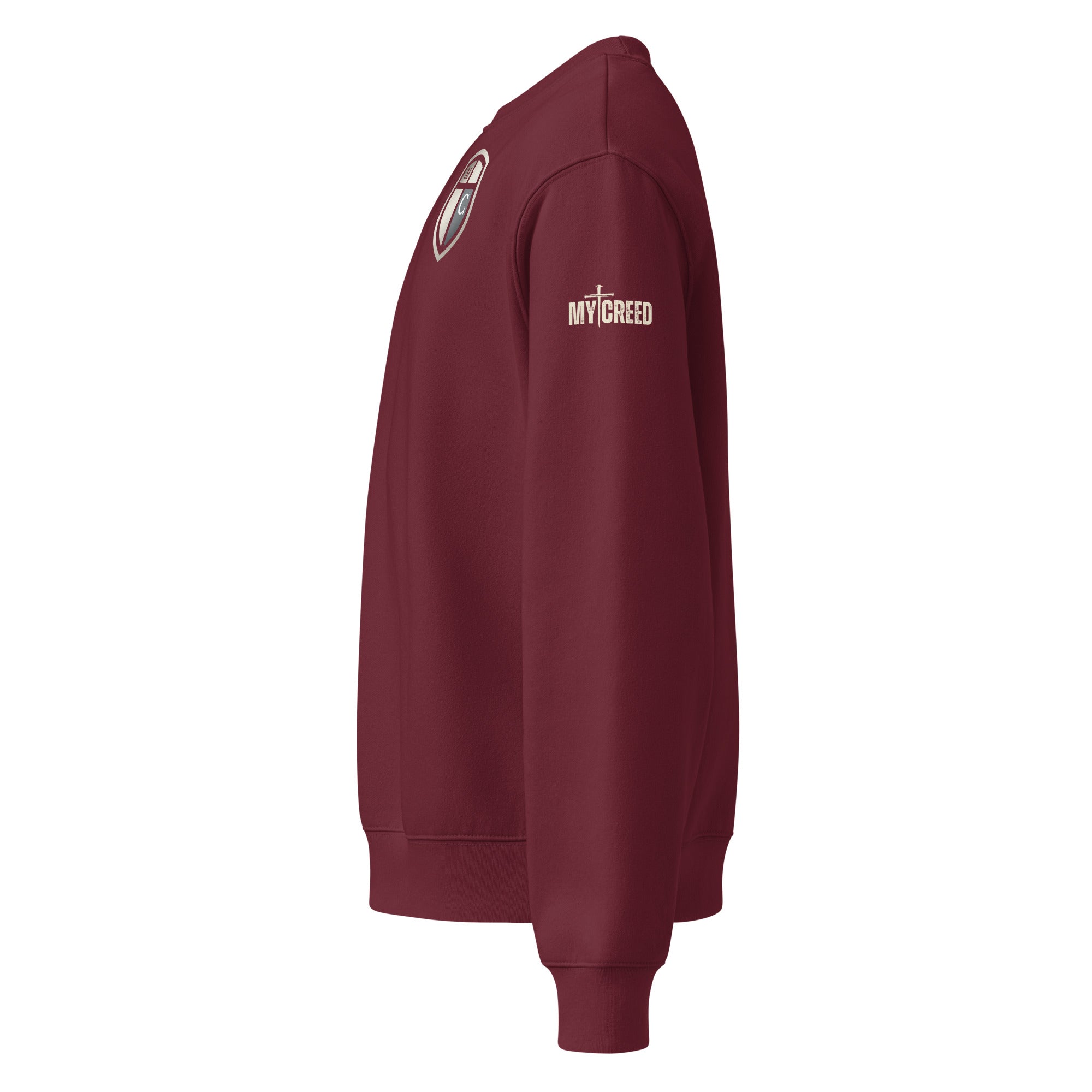 Maroon crewneck sweatshirt left side view highlighting the unisex silhouette, premium fleece texture, and subtle branding details, by MyCreed™
