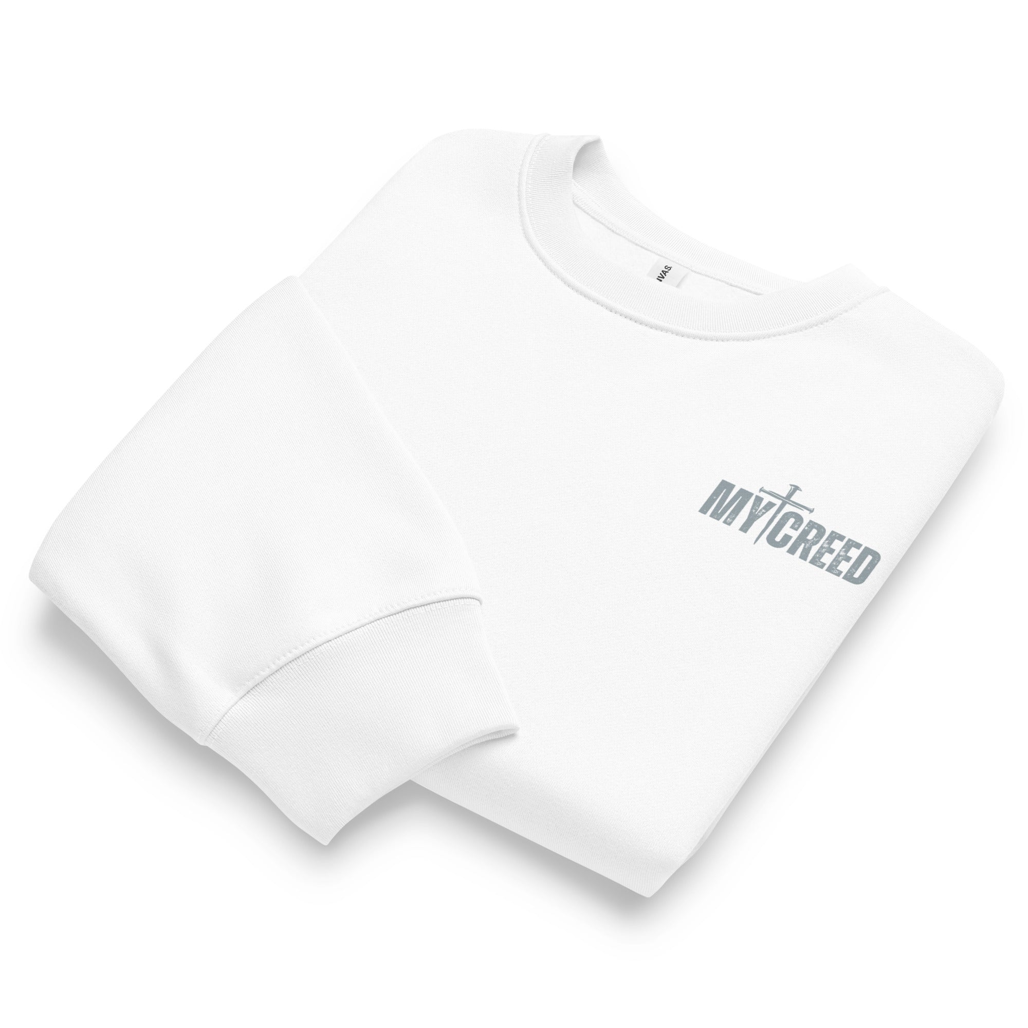 Folded white Bella+Canvas 4711 oversized sweatshirt highlighting soft fabric and MyCreed branding, by MyCreed™