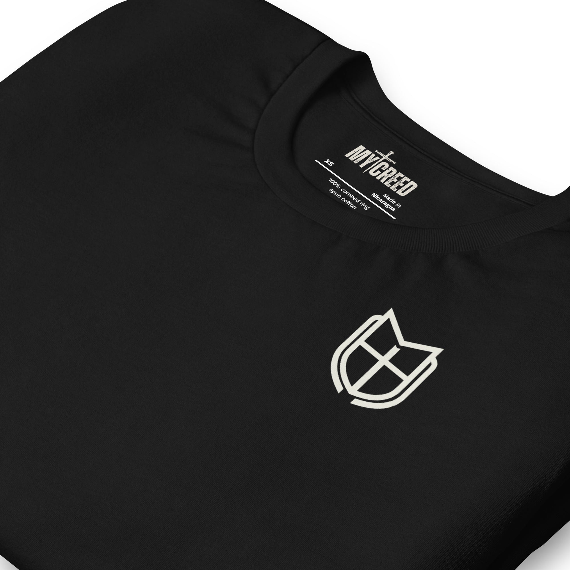 Close-up detail of black t-shirt sleeve with MyCreed shield emblem print, by MyCreed™